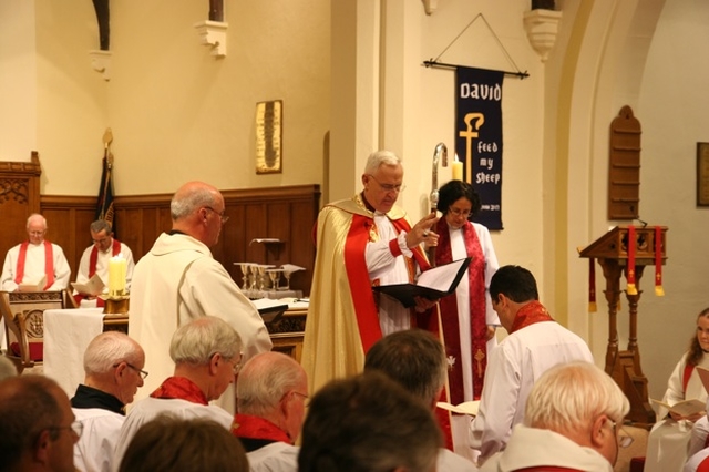 The Archbishop of Dublin and Bishop of Glendalough, the Most Revd Dr John Neill blesses the Revd David Mungavin at his institution as Rector of Greystones.