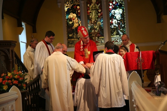 Pictured are the Archbishop of Dublin and Bishop of Glendalough, the Most Revd Dr John Neill and Diocesan clergy laying hands on the Revd Terry Alcock at her ordination to the priesthood in St James' Church, Castledermot, Co Kildare.