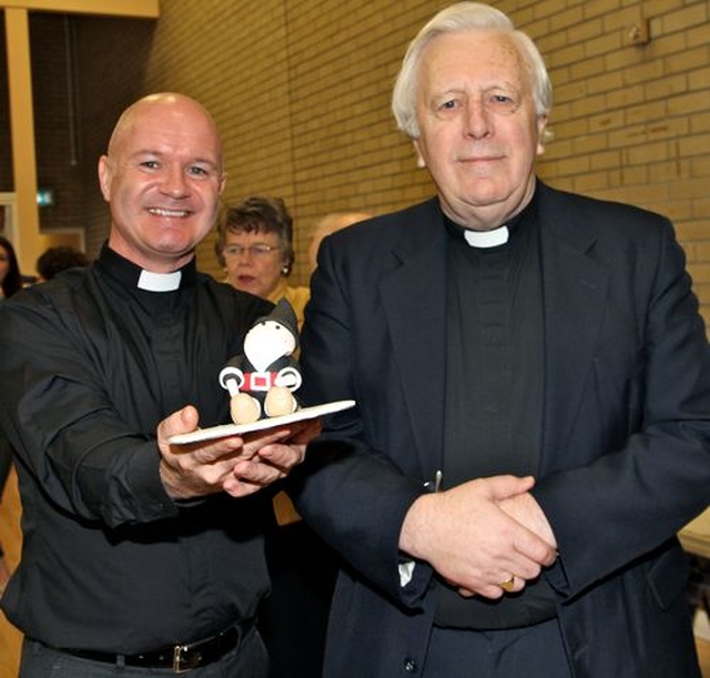 Black Santas Canon David Gillespie and Dean Houston McKelvey with a mini Black Santa baked specially for the distribution of funds service at St Ann’s, Dawson Street. 