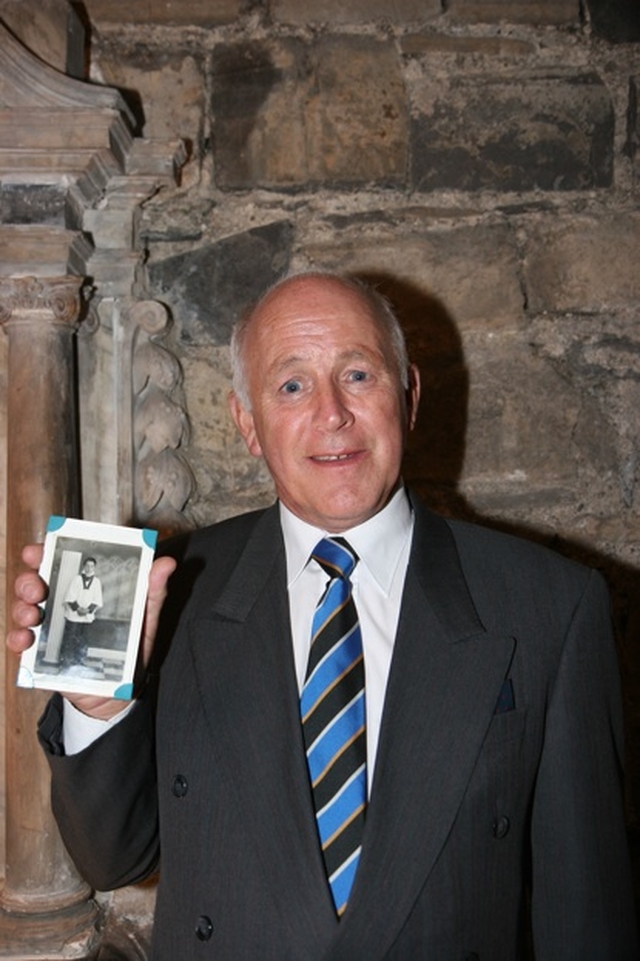 Pictured is Robert Olliffe who was a chorister of Christ Church Cathedral from 1957-1961 with a photograph of himself during those years. He is pictured at a reception for former choristers of Christ Church.