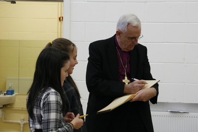 The Most Revd Dr John Neill, Archbishop of Dublin, is among the first to sign the Visitors' Book at the all-new Springdale National School.