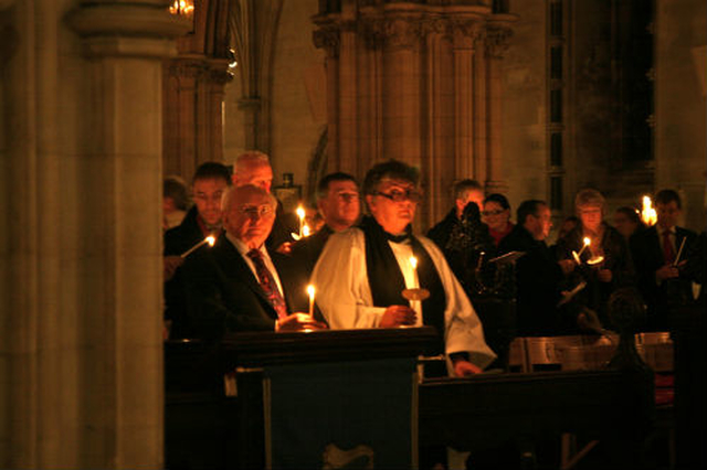 President Michael D. Higgins holds his candle as the congregation at the ‘In Darkness There is Light Service’ partake in an act of solidarity with the Irish people. Also pictured is Canon Aisling Shine. 