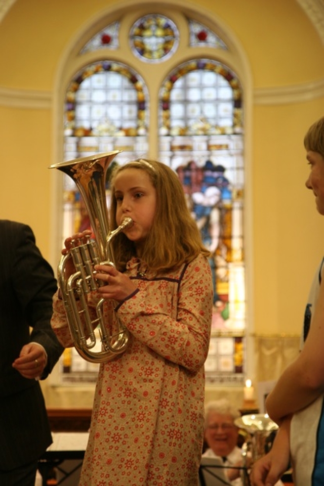 One of the young people present at the Sunday School Society's Concert tries her hand at the Euphonium. The concert marked 200 years of the society's existence.