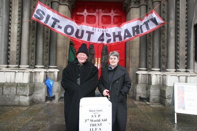 Dublin's 'Black Santas' the Revd Canon Tom Haskins [retired] Vicar of St Ann's and his former Curate, the Revd Joyce Rankin during their sit out for charity (9am - 6pm daily) until Christmas Eve (starts later on Sunday).