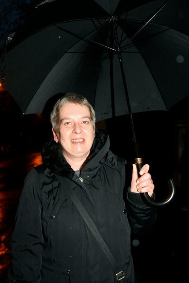 Uta Raab of the Dublin Council of Churches shelters from the rain on the Ecumenical Walk of Light which took place on Sunday November 25. 