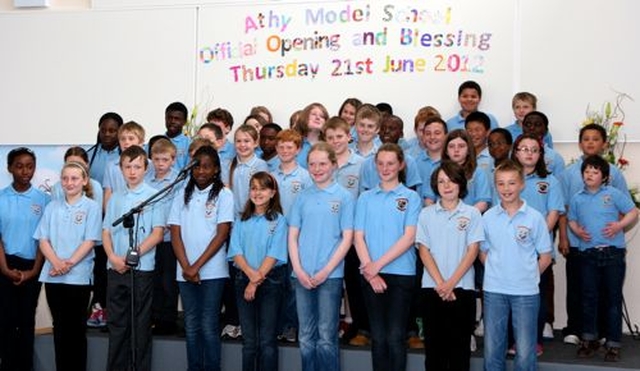 Third to sixth classes at Athy Model School perform at the official opening of their new school building. 