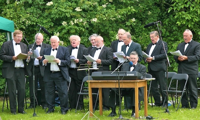 The Male Voice Choir of the Dublin Conservative Club performing at St Doulagh's Annual Open Air Service of Praise and Thanksgiving in St Doulagh's Field, Malahide Road, Balgriffin.