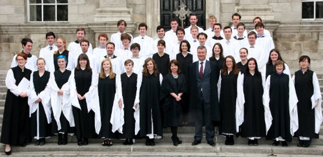 Members of the Trinity Chapel Choir pose on the steps of the Dining Hall with Provost Patrick Prendergast and Vice Provost Linda Hogan. 