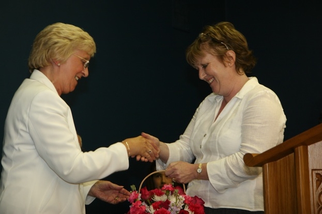 Niamh O'Mahony, Churchwarden of Greystones (right) presents a bouquet of flowers to Betty Neill at the institution of the Revd David Mungavin as Rector of Greystones.