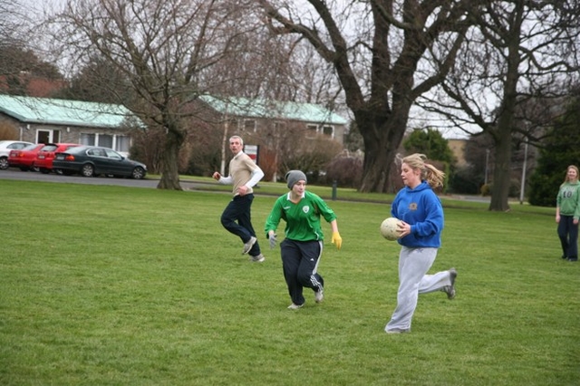 Student of the Church of Ireland College of Education playing Gaelic Football on the college green.