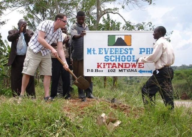 Graham Kinch, CORE Congregent puts in the sign for the new Mount Everest Primary School in Kitandwe, Uganda. He and Ian Taylor climbed four world peaks, culminating in Mount Everest to raise money through Fields of Life to build the School.  