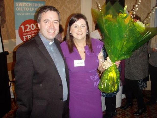 Rector of Narraghmore and Timolin with Castledermot and Kinneagh, the Revd Isaac Delamere presents flowers to the coordinator of the Neven Maguire Cookery Evening, Fiona Hawkins.