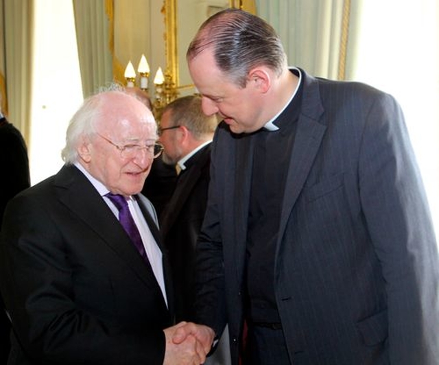 President Michael D Higgins and Canon Roy Byrne at Áras an Uachtaráin at the reception to mark the centenary of Cumann Gaelach na hEaglaise. 