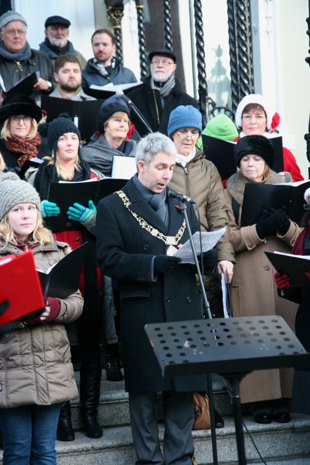 The Lord Mayor, Andrew Montague, reads a lesson at the community carol singing outside the Mansion House. 