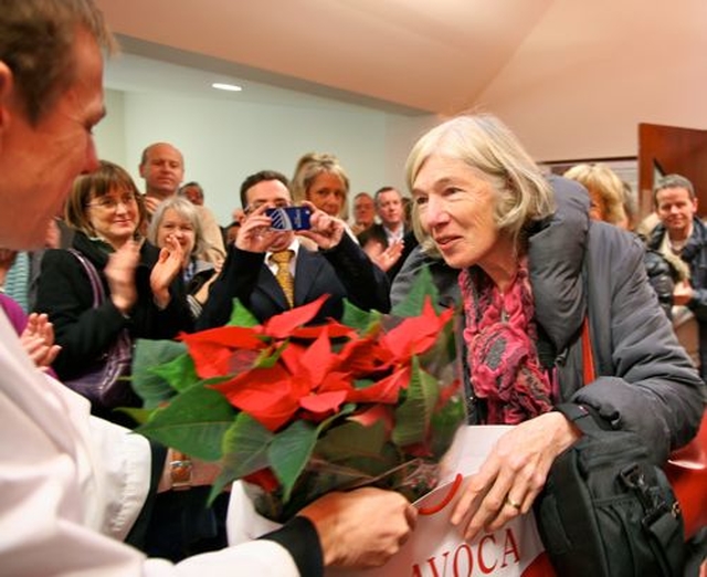 Anne Fleeton is presented with flowers for ‘doing without’ her husband Bill for extended periods during the renovation of St Matthias’s church hall which was officially opened on Sunday November 25. 