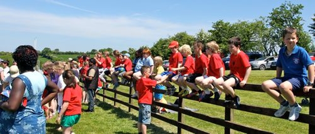 On the fence – some of the spectators at the West Glendalough Children’s Choral Festival observe the race at the sports day which took place in Dunlavin GAA on Friday June 7. 