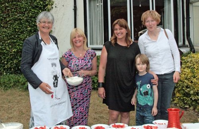 Margaret Wynne, Ann Maguire, Jenny Carty, Flora Simms and a young helper prepare for the Sandford and Milltown Parish Strawberries and Wine evening. 