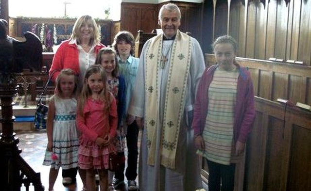 Archbishop Michael Jackson with some of the children who attended the Service of Thanksgiving for the restoration work which has taken place at Glenealy Church. 
