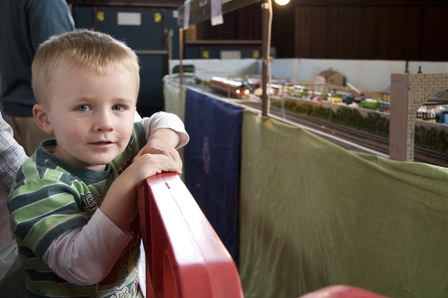 A young train enthusiast enjoying the exhibition.