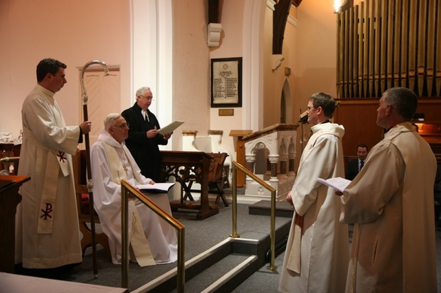 The Registrar, the Revd Canon Victor Stacey (3rd left) reads the Act of Institution at the Institution of the Revd Canon Mark Gardner (2nd right) as Vicar of the St Patrick's Cathedral Group of Parishes in St Catherine's Church, Donore Avenue. Also pictured (left to right) are the Archbishop's Chaplain, the Revd David MacDonnell, the Archbishop of Dublin, the Most Revd Dr John Neill and the Archdeacon of Dublin, the Venerable David Pierpoint.