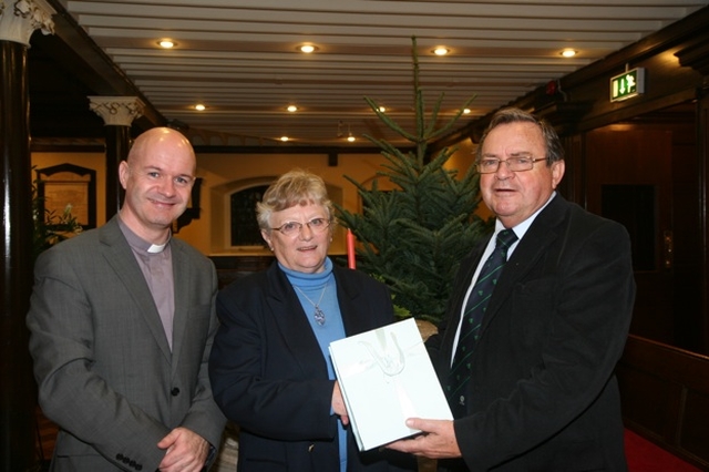 Arthur Vincent (right) presents Rosemary Bourne with a token of appreciation for her six years work in the parish office of St Ann's, Dawson Street. Also pictured is the Vicar of St Ann's, the Revd David Gillespie (right).