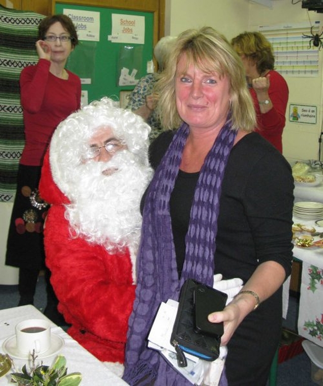 Santa hears Linda Evan’s Christmas List at the recent Sandford Parish Christmas Bazaar.