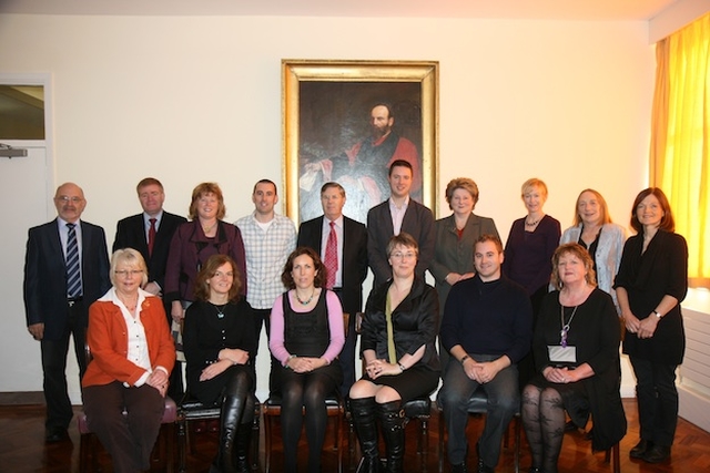 Staff of the Church of Ireland College of Education, including principal Anne Lodge, pictured before a portrait of The Revd H Kingsmill Moore who was principal of the college from 1884-1927.