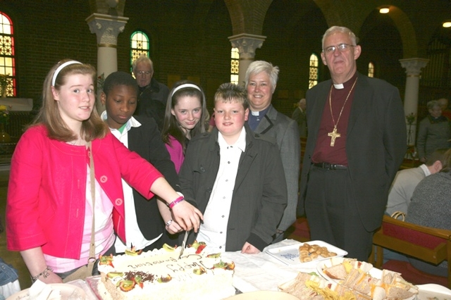Pictured are four newly confirmed young people from Dublin about to cut the celebratory cake at their confirmations. They are pictured with the Revd Canon Katharine Poulton and the Archbishop of Dublin, the Most Revd Dr John Neill.
