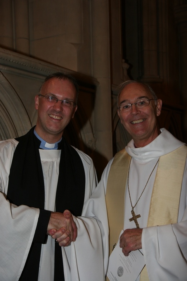 The Archbishop of Armagh, the Most Revd  Alan Harper (right) congratulating the Revd Dr Maurice Elliott on his commissioning as Director of the Church of Ireland Theological Institute.