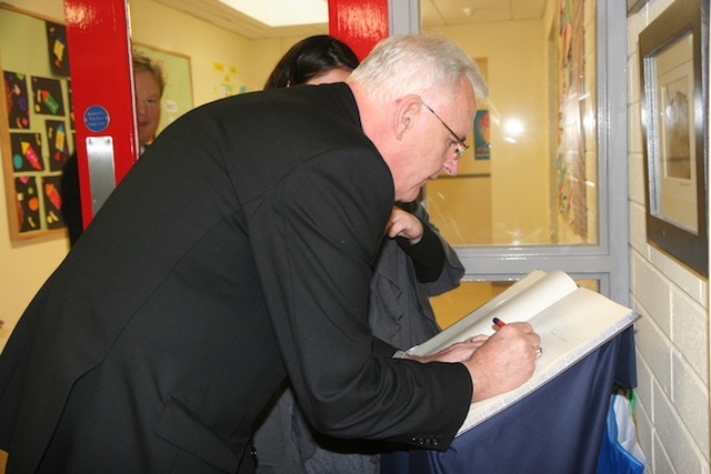 Archbishop Neill is among the first to sign the visitors book at the official opening of Castleknock National School's new extension.