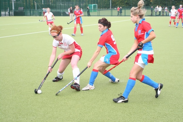 Pictured is action from a Hockey match between Alexandra College (red and white) and Mount Sackville (blue and red). The match was part of a programme of events to mark the official opening of two new pitches and one all purpose court in Alexandra College. The match was played on the Jenny Robinson (nee Telford) pitch named after a prominent ex-student. Alexandra College won the match 2-1.