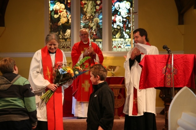 The Revd Terry Alcock, newly ordained to the priesthood receives a bunch of flowers from two young people from the nearby school at her ordination in St James' Church, Castledermot. Looking on are the Archbishop of Dublin and Bishop of Glendalough, the Most Revd Dr John Neill and the Revd Isaac Delamere, Rector of Narraghmore and Timolin with Castledermot and Kinneagh.