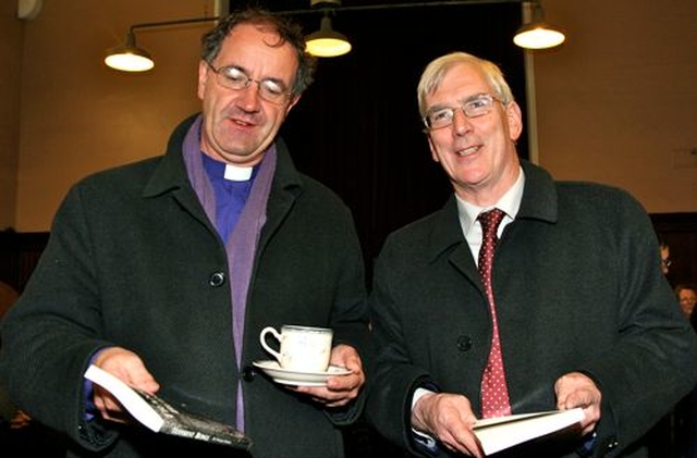 Bishop Michael Burrows and Michael Gleeson peruse their copies of Transient Beings by Patrick Semple at the book launch in the Knox Hall in Monkstown. 
