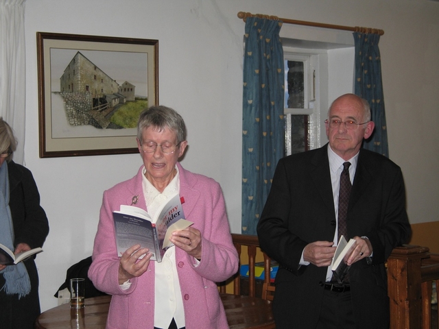 Reading from her memoir Over my Shoulder at the book’s launch is the Revd Norma MacMaster, watching (right) is Artist and Writer, Hugh Fitzgerald Ryan.