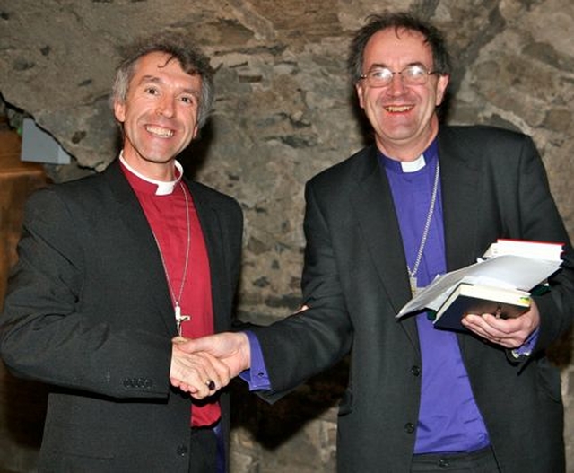 Bishop Michael Burrows (right) presents Bishop Andrew John with a copy of Cumann Gaelach na hEaglaise’s new Bilingual Services book at its launch in Christ Church Cathedral. Bishop John was part of a Welsh delegation who shared their experiences of establishing bilingual texts for the Church in Wales.  