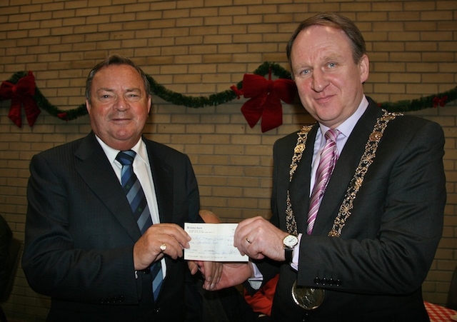 Arthur Vincent, Treasurer at St Ann's, presenting the Lord Mayor of Dublin, Gerry Breen, with a cheque for €900. The money was raised for the Lord Mayor's Charities by a collection during the Civic Carol Service in St Ann's Church, Dawson Street. 