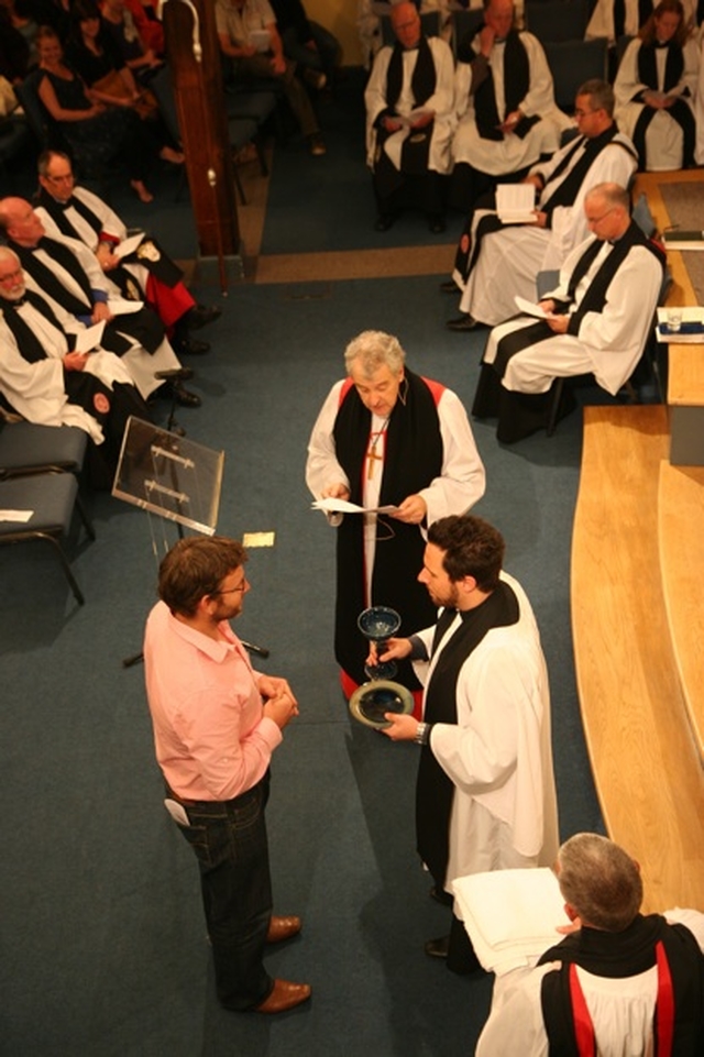 The Revd Craig Cooney (right) receives a chalice and paten from Greg Jones at his introduction as Minister in Charge of CORE.
