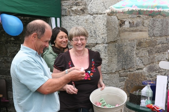 The Revd Canon George Butler, Rector of Castlemacadam, Ballinatone and Aughrim draws the first raffle winner at the Ballinatone Parish Fete in Co Wicklow.