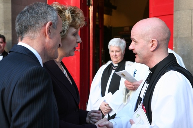 The Revd David Gillespie, Vicar of St Ann's greets Mary McAleese, President of Ireland and her husband, Dr Martin McAleese at the Service of Commemoration and Thanksgiving to mark ANZAC Day. In the background is the Revd Canon Katharine Poulton who was Chaplain to the President during the service.