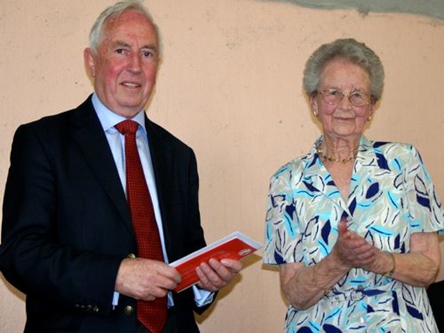 Dean Stacey receives a travel voucher from his former parishioners presented by Betty McKee (photo: Chris Henderson)