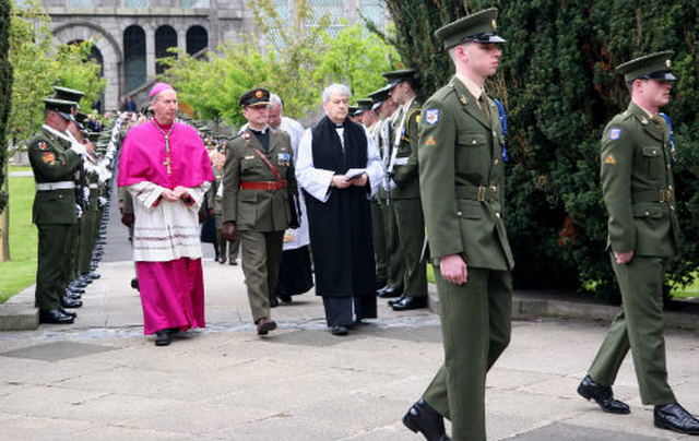 Archbishop Michael Jackson passes the guard of honour before taking part in the 1916 Commemoration Ceremony at the graveside of the leaders of the Easter Rising in Arbour Hill.