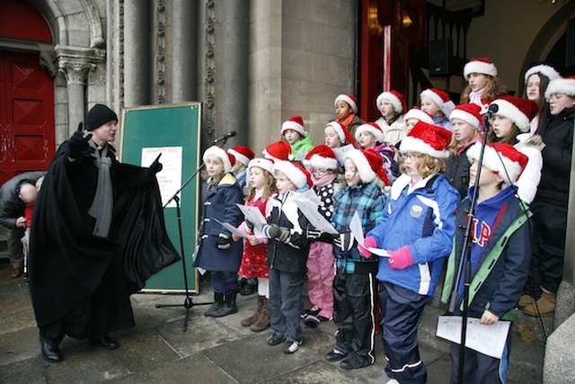 The Vicar of St Ann’s, the Revd David Gillespie, conducting the Taney Youth Choir at the launch of the ‘Black Santa’ Christmas Appeal at St Ann’s Church on Dawson Street. 