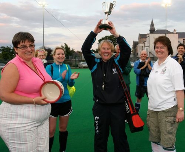 The captain of the victorious Dalkey team raises the cup following the Diocesan Inter–Parish Hockey Tournament which took place in St Andrew’s College, Booterstown. Also pictured are organisers, Revd Gillian Wharton and Revd Anne Taylor.