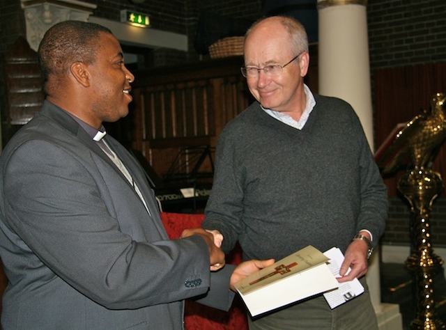Prof Kjell Nordstokke presenting the Revd Obinna Ulogwara, Rector of St George and St Thomas' Parish, with a copy of his book 'Liberating Diakonia' as token of appreciation following the visit of a delegation from Diakonhjemmet University in Norway to the parish church.
