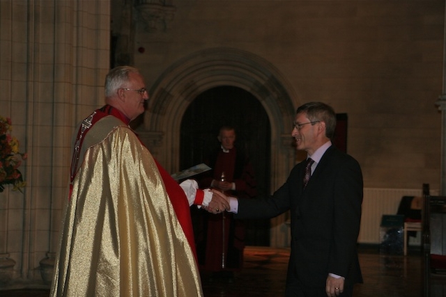 Archbishop John Neill presenting Tom Healy with a certificate for completing the Archbishop's Certificate Course in Theology. 