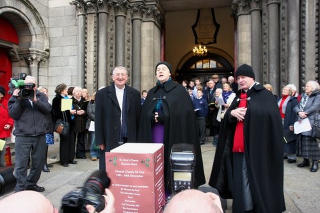 Archbishop Diarmuid Martin, Archbishop Michael Jackson and Vicar of St Ann’s Revd David Gillespie accompany the Seafield Singers and the children of the Catholic University School while the cameras capture the action during the Black Santa Appeal.