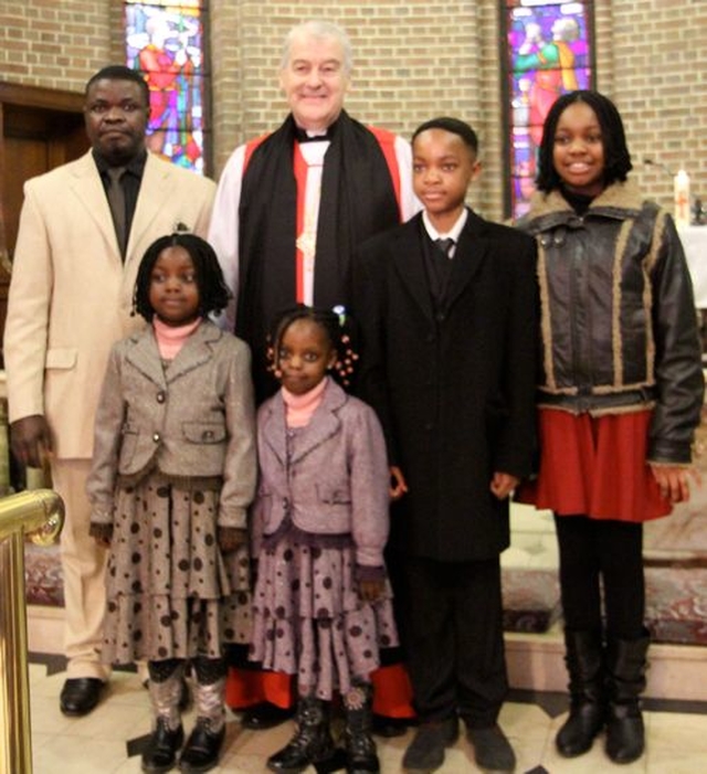 Archbishop Michael Jackson with the Okhueleigbe family following the Discovery International Carol Service in St George and St Thomas’s Church on December 8. 