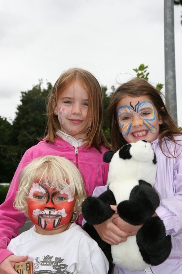 Three recently face-painted youngsters show off their new look.