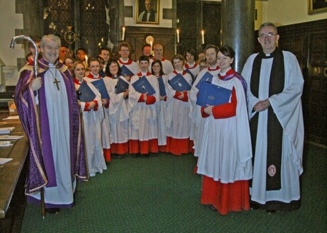 Arcbishop Michael Jackson, Dean Dermot Dunne, Director of Music, Judith Gannon, and the choir of Christ Church cathedral in the chapter room following the Advent Carol Service in late November 2011.