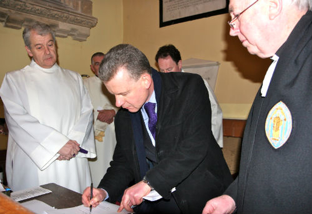 Church warden at St George’s Church in Balbriggan, Trevor Sargent, signs the register witnessed by the Archbishop of Dublin, the Most Revd Dr Michael Jackson and registrar, Canon Victor Stacey, at the Service of Introduction of the Revd Anthony Kelly as Bishop’s Curate of the parishes of Holmpatrick and Kenure with Balbriggan and Balrothery.